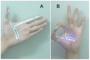 A researcher demonstrates  a circuit made with gallium paint, c/o Yu et al.