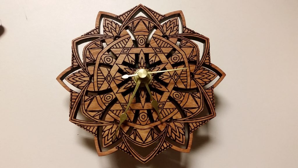 Laser cut clock with a 12-point mandala face